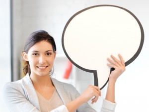 smiling businesswoman with blank text bubble